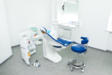 Blurred view of dentist's office interior with chair and equipment