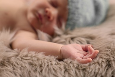 Photo of Cute newborn baby sleeping on fluffy blanket, selective focus