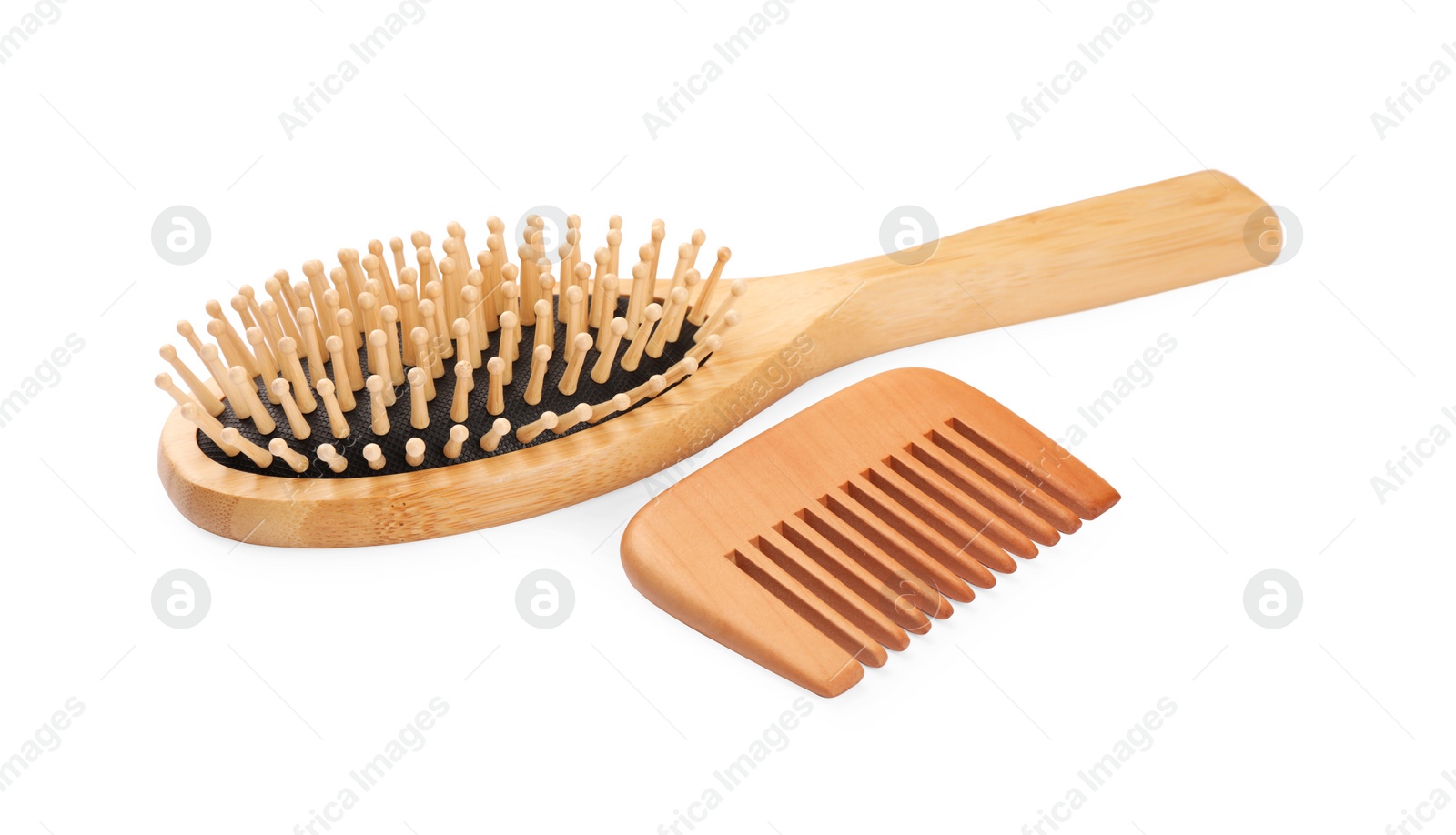 Photo of New wooden hair brush and comb isolated on white