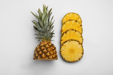 Composition with cut raw pineapple on white background, top view