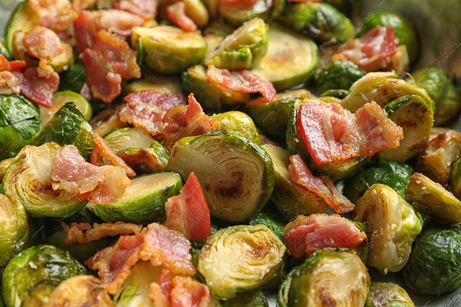Photo of Delicious roasted Brussels sprouts with bacon as background, closeup