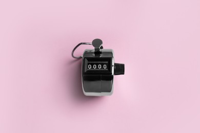 Modern timer on pink background, top view