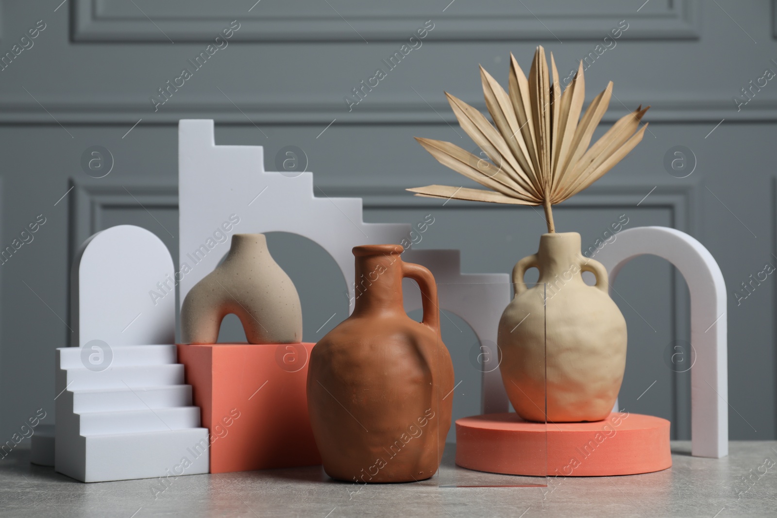 Photo of Clay flagons and other decorative elements on grey table
