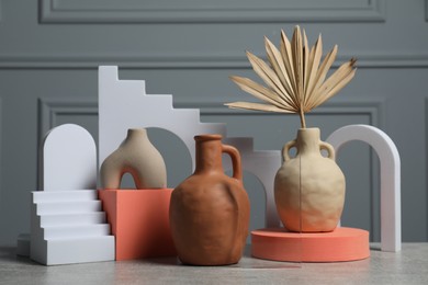 Clay flagons and other decorative elements on grey table