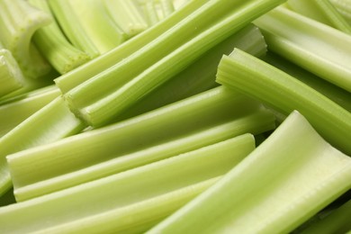 Fresh green cut celery as background, closeup