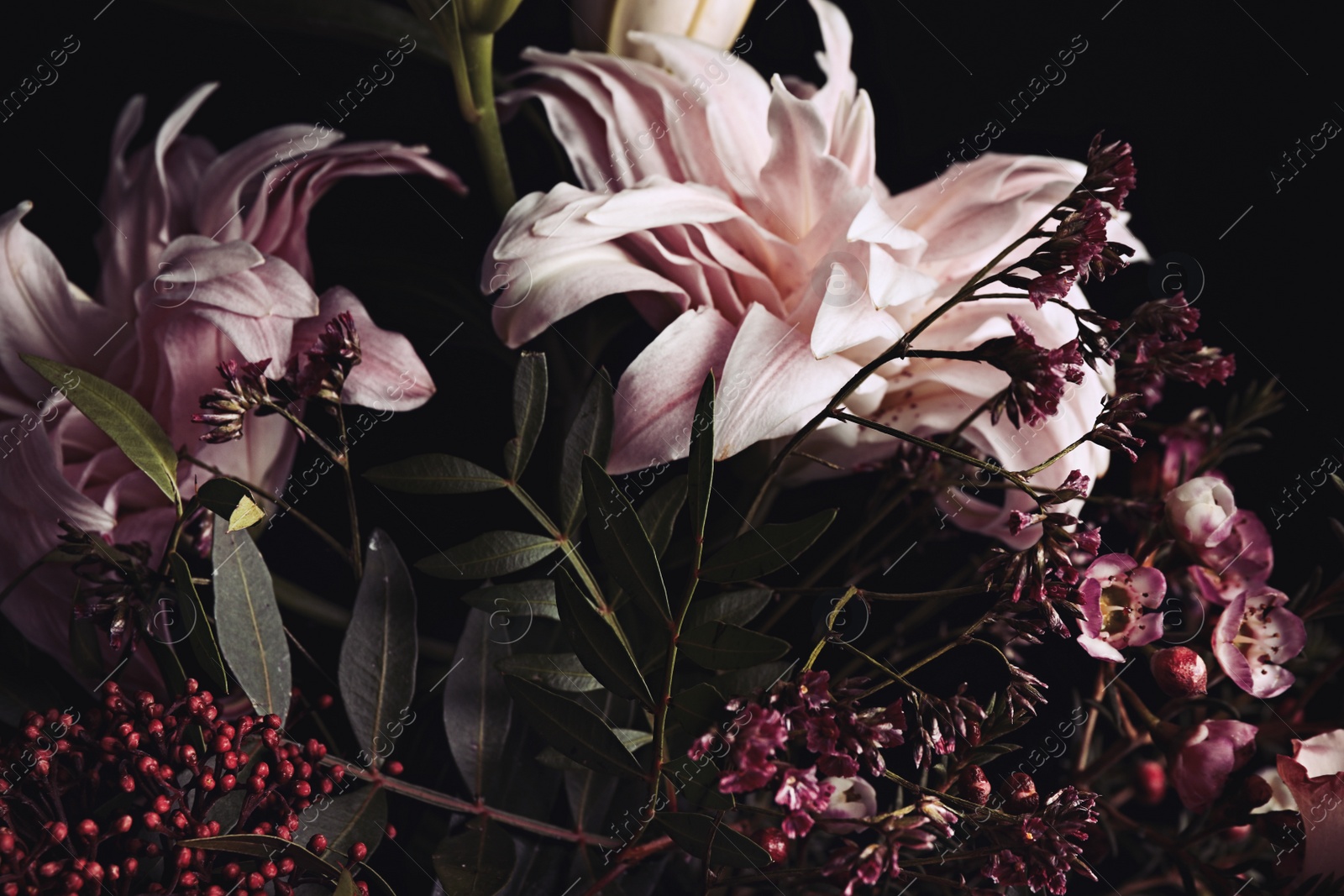 Photo of Beautiful bouquet of different flowers on black background, closeup. Floral card design with dark vintage effect