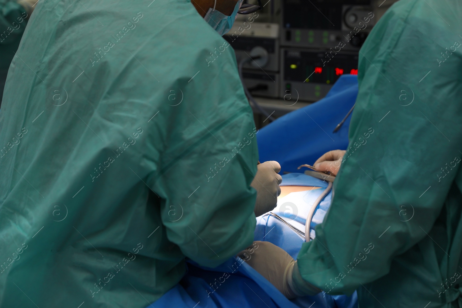 Photo of Medical team performing surgery in operating room, closeup