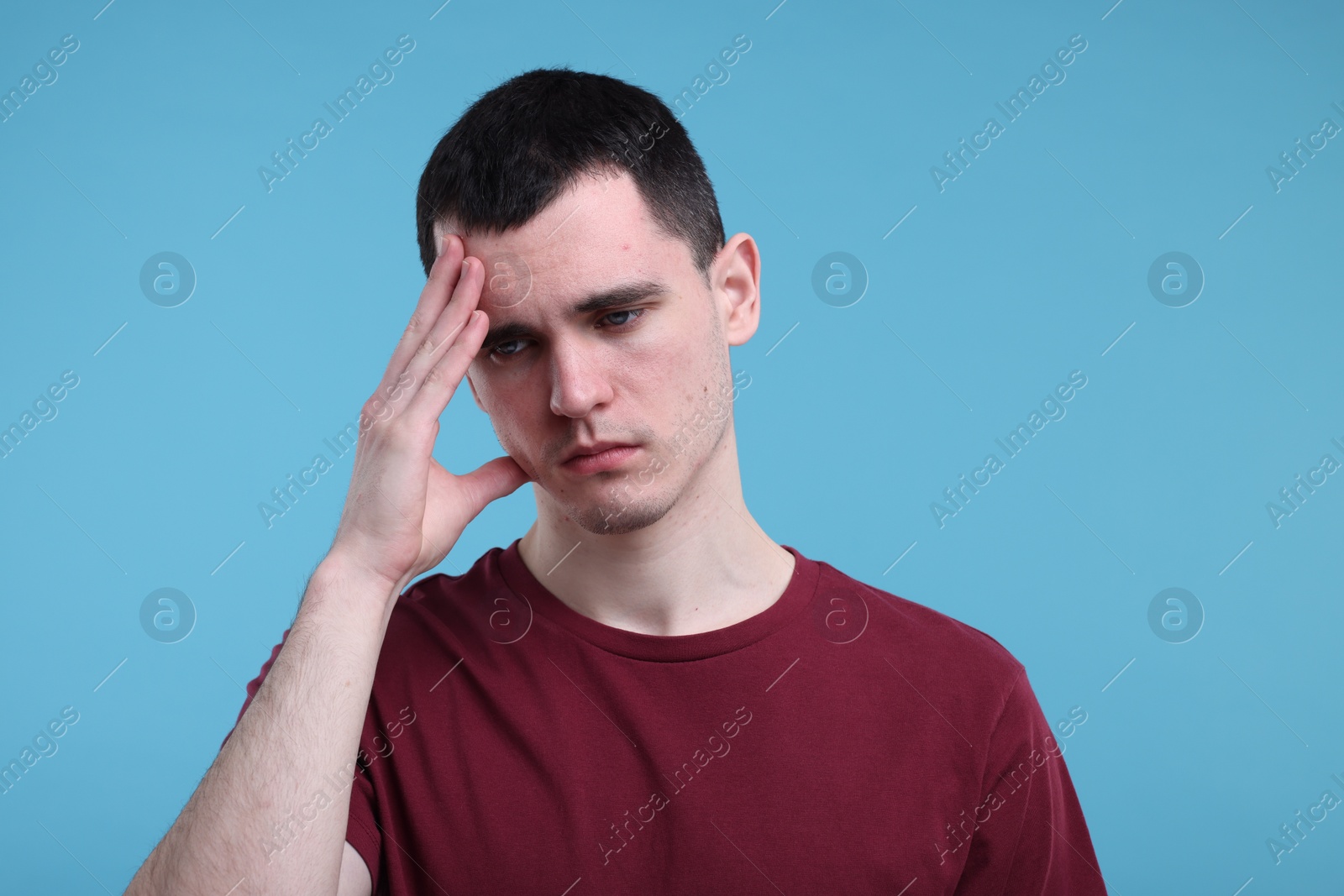 Photo of Portrait of sad man on light blue background