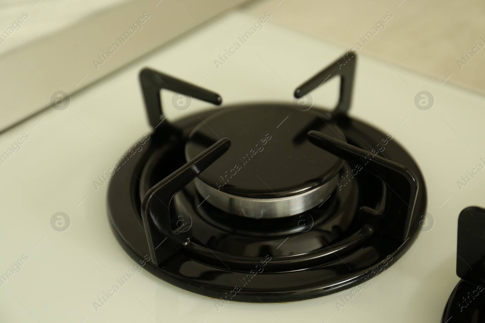 Photo of Gas burner of modern stove, closeup view