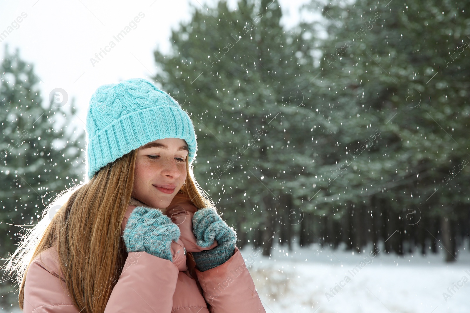 Photo of Portrait of teenage girl in winter snowy forest