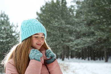 Portrait of teenage girl in winter snowy forest