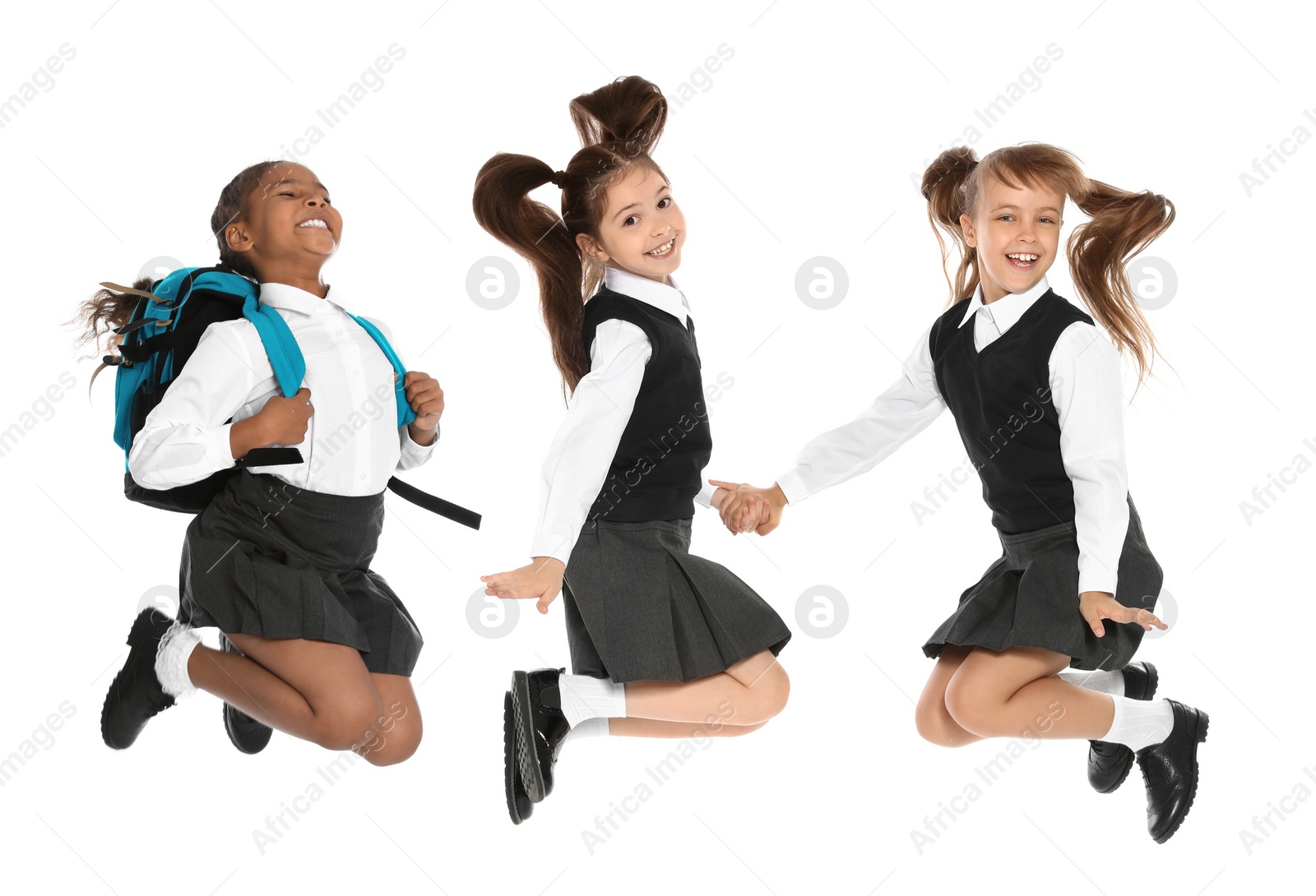 Image of Children in school uniform jumping on white background