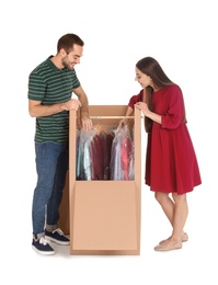 Photo of Young couple near wardrobe box on white background