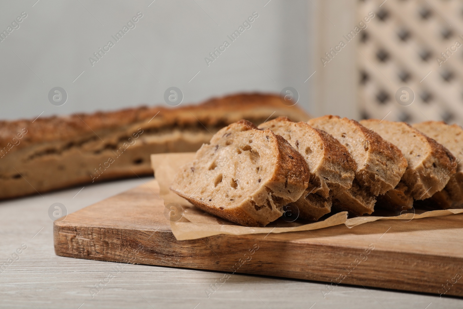 Photo of Cut tasty buckwheat baguette on wooden table