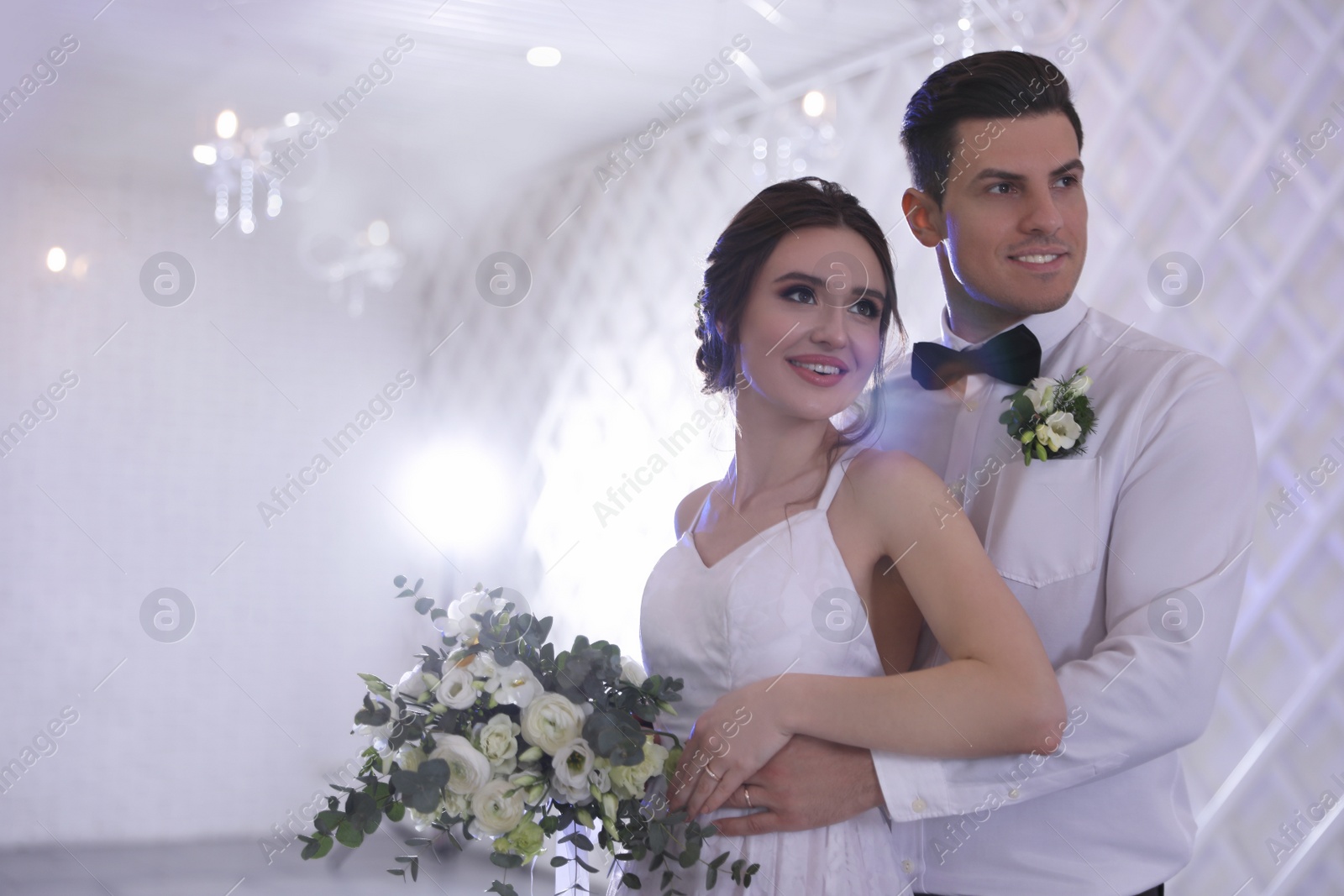 Photo of Happy newlywed couple together in festive hall. Space for text