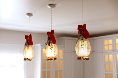 Photo of Hanging lamps decorated for Christmas indoors. Interior design