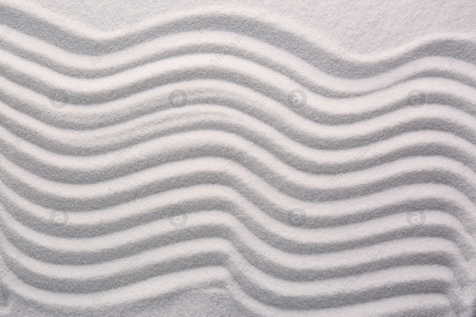 Photo of White sand with pattern as background, top view. Concept of zen and harmony