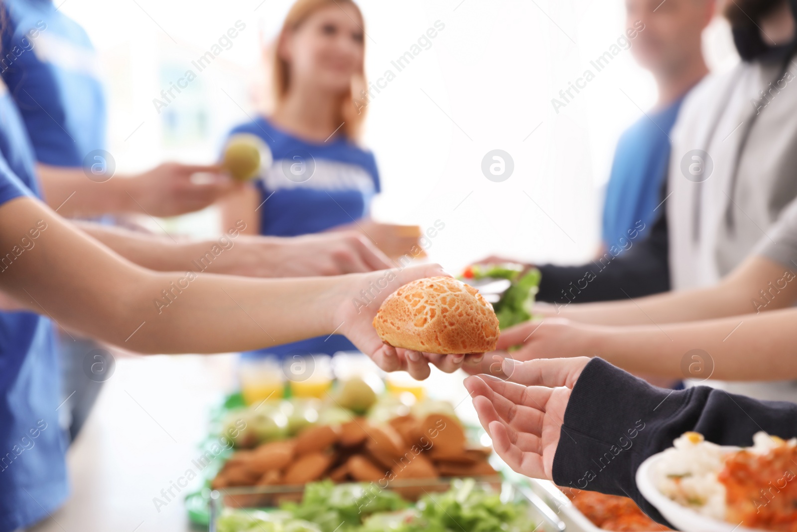 Photo of Volunteers serving food to poor people, closeup