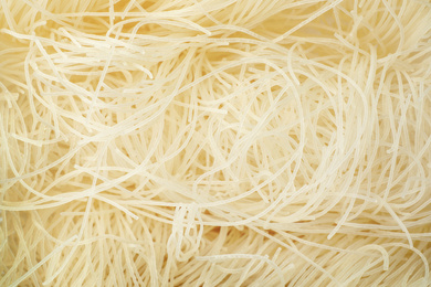 Raw rice noodles as background, closeup view