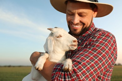 Man with goat at farm. Animal husbandry