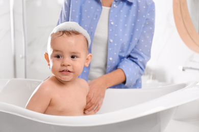 Mother with her little baby in bathroom