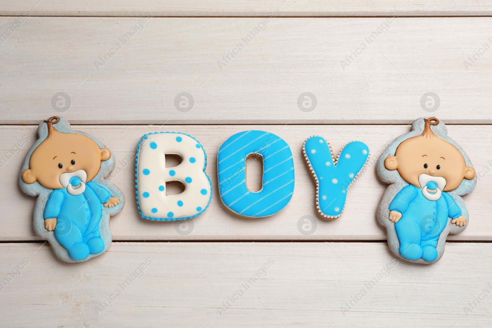 Photo of Word Boy made of tasty cookies on white wooden table, flat lay. Baby shower party