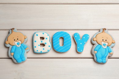 Photo of Word Boy made of tasty cookies on white wooden table, flat lay. Baby shower party