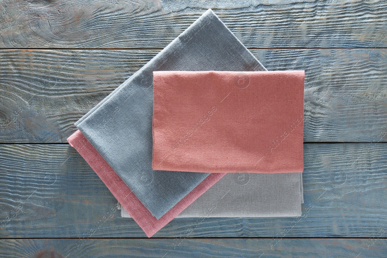 Photo of Different colorful napkins on wooden table, top view