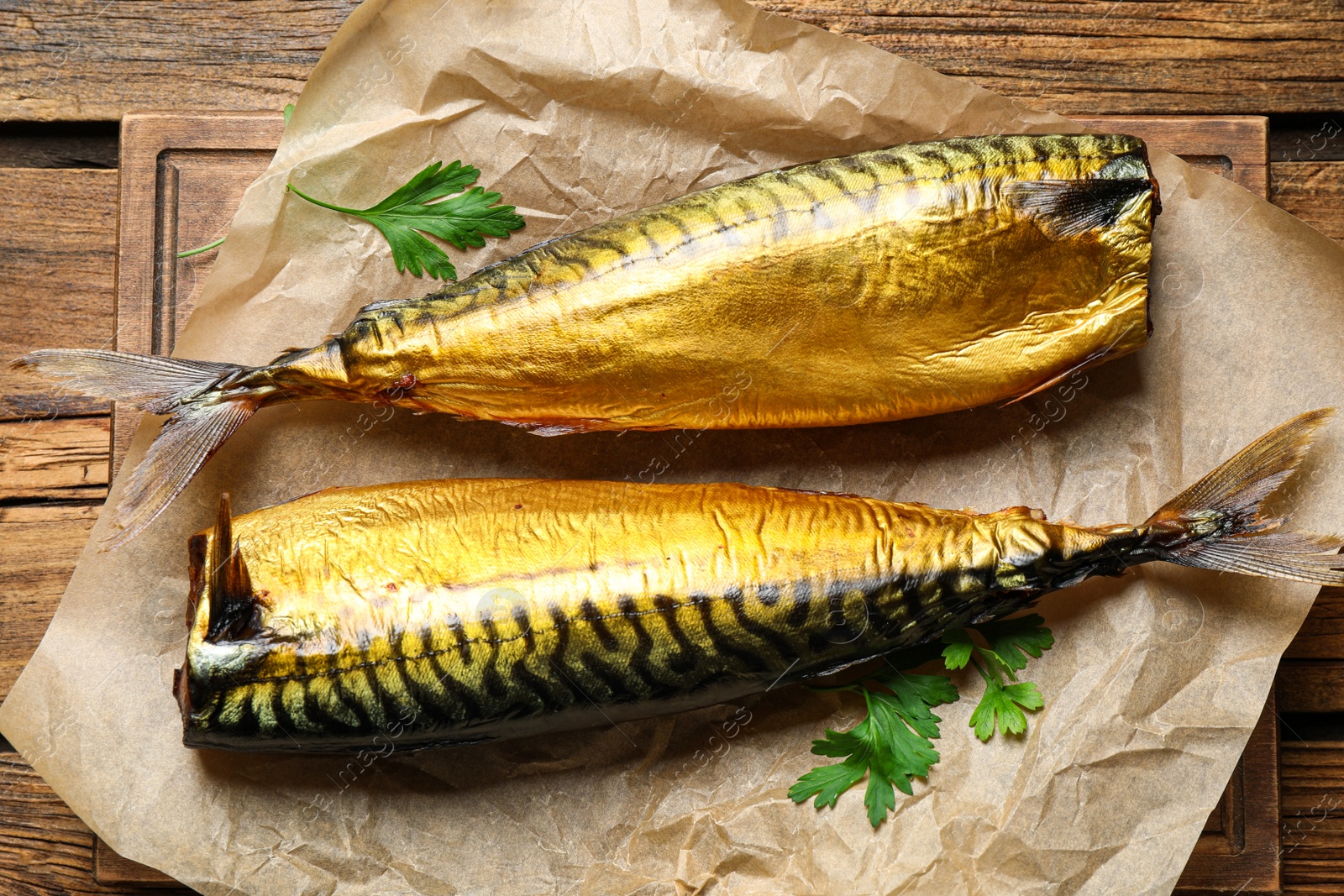 Photo of Tasty smoked fish on wooden table, top view