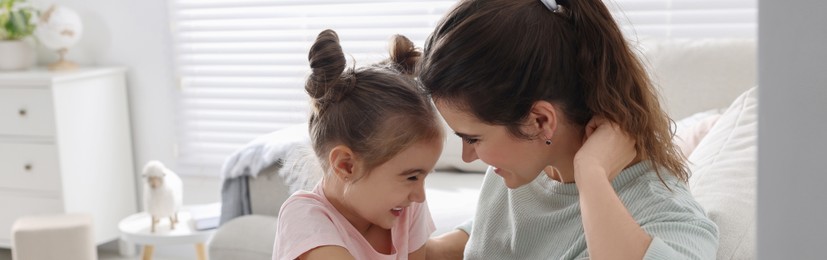 Image of Mother and her little daughter spending time together at home, banner design