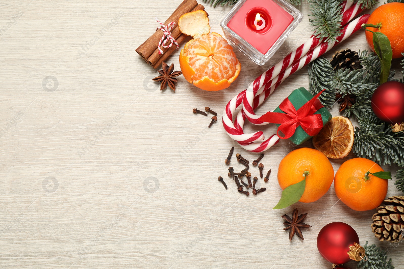 Photo of Flat lay Christmas composition with fresh tangerines on light wooden table. Space for text