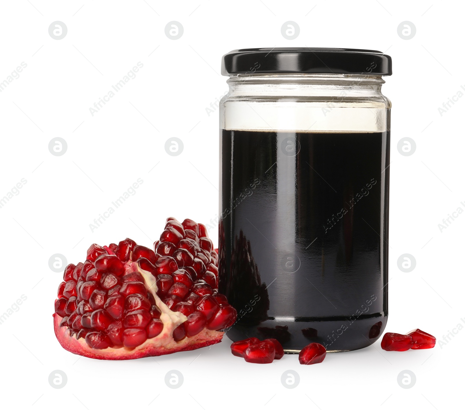 Photo of Glass jar of pomegranate sauce and fresh ripe fruit on white background