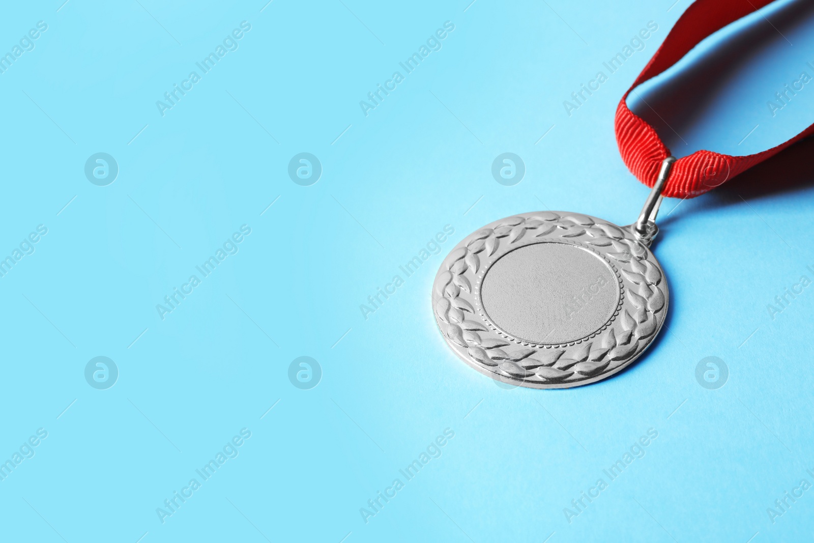 Photo of Gold medal with space for design on color background. Victory concept