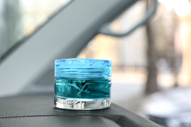 Stylish air freshener on dashboard in car