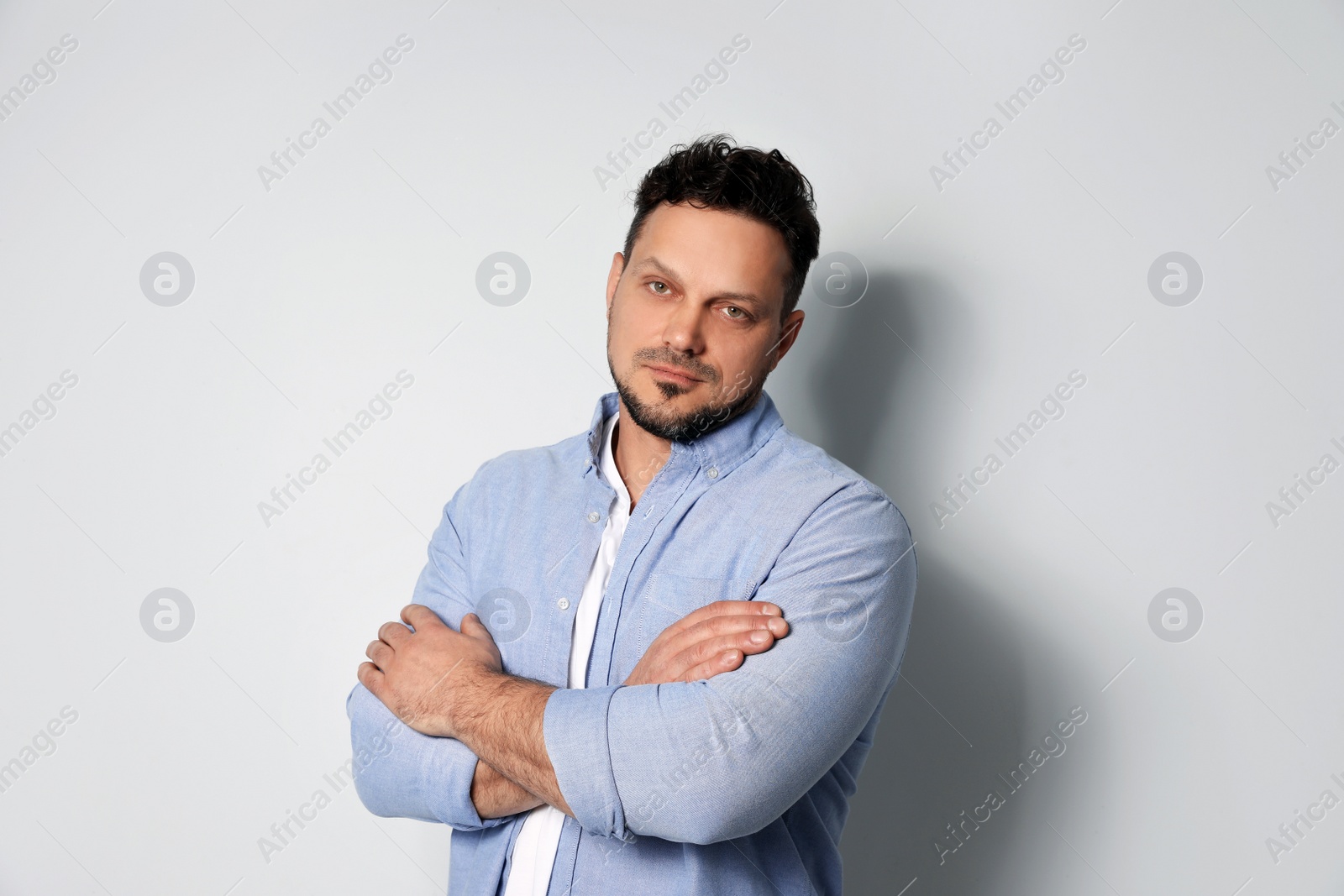 Photo of Portrait of handsome man on light grey background