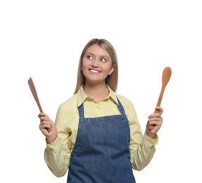 Photo of Beautiful young woman in denim apron with cooking utensils on white background