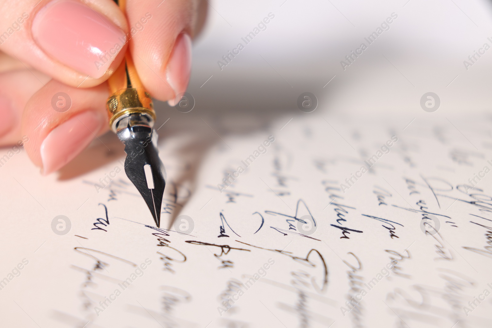 Photo of Woman writing letter with fountain pen, closeup