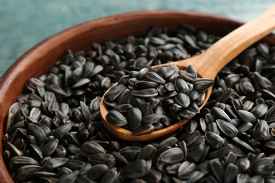 Photo of Bowl and spoon with sunflower seeds, closeup