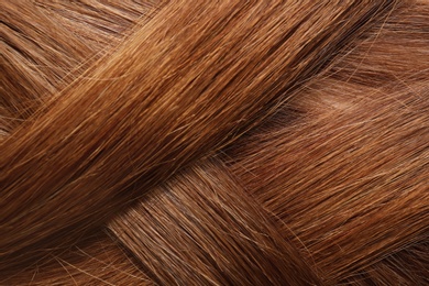 Texture of healthy red hair as background, closeup