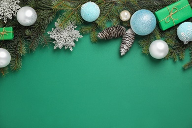 Photo of Fir branches with Christmas decoration on green background, flat lay. Space for text