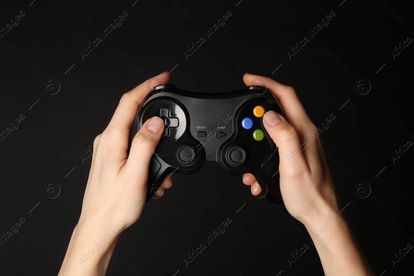 Photo of Woman using game controller on black background, closeup