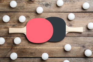 Ping pong rackets and balls on wooden table, flat lay