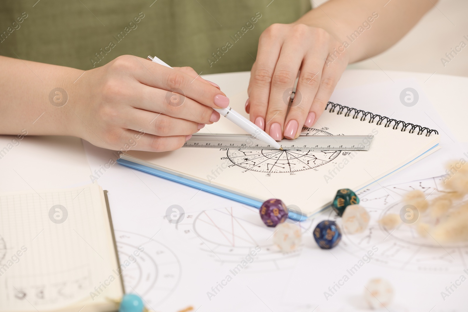 Photo of Astrologer using zodiac wheel for fate forecast at table, closeup. Fortune telling