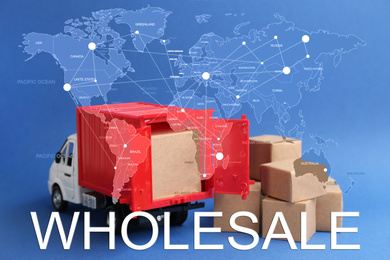 Wholesale business. World map and truck model with carton boxes on background
