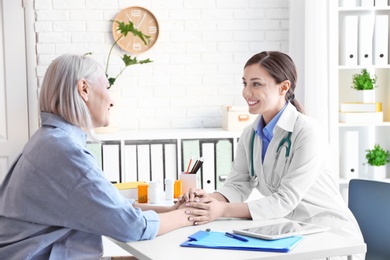 Photo of Female doctor consulting patient in clinic