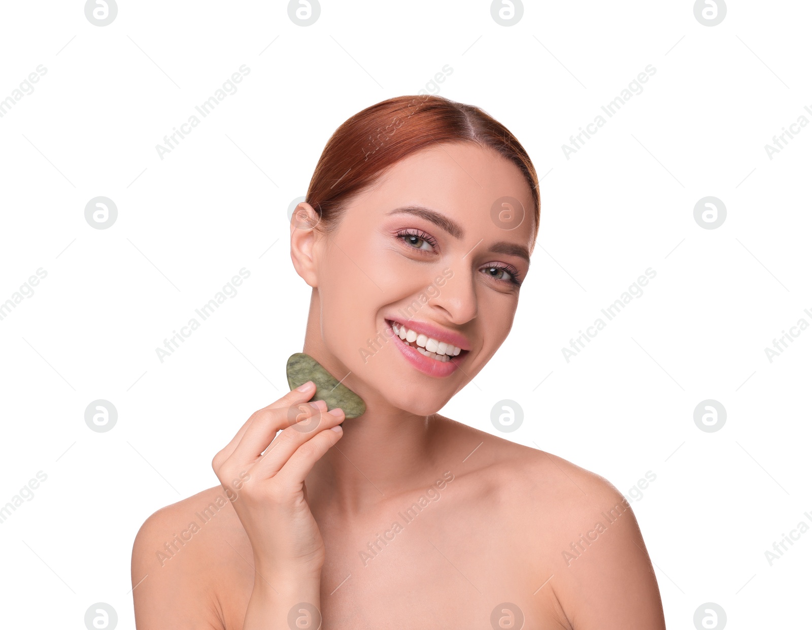 Photo of Young woman massaging her face with jade gua sha tool isolated on white