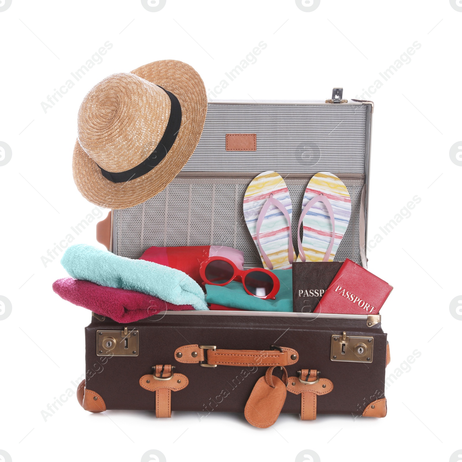 Photo of Open vintage suitcase with clothes packed for summer vacation isolated on white