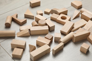 Photo of Wooden building blocks set on floor. Child's toy