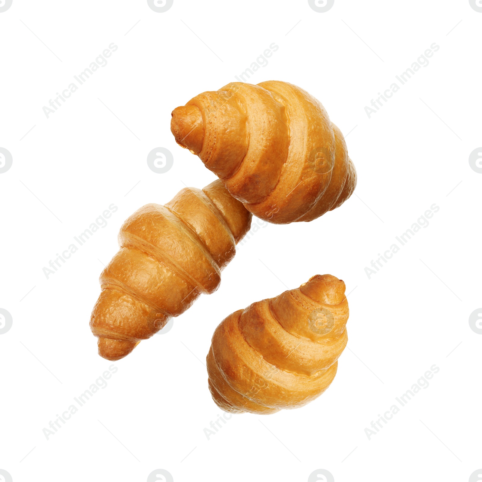 Image of Crusty golden croissants falling on white background