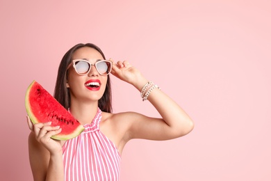 Photo of Beautiful young woman posing with watermelon on color background